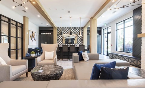 a living room with a couch and chairs and a table